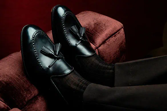 Black shell cordovan tassel loafers by Carmina Shoemaker